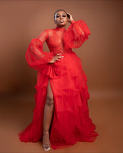 Load image into Gallery viewer, Front view of the red lace maxi dress with a right-leg high slit and bow detail.